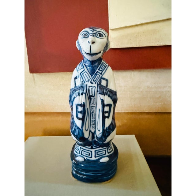 A striking vintage blue and white porcelain monkey figure rendered in a rich cobalt glaze with traditional Asian-inspired...