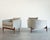 A refined pair of 1950s tripod barrelback lounge chairs in the style of Jens Risom, showcasing clean mid-century lines and...