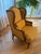 Comfortable Old English-style Wing Backed Arm Chair. Mustard gold fabric with wood frame supports.