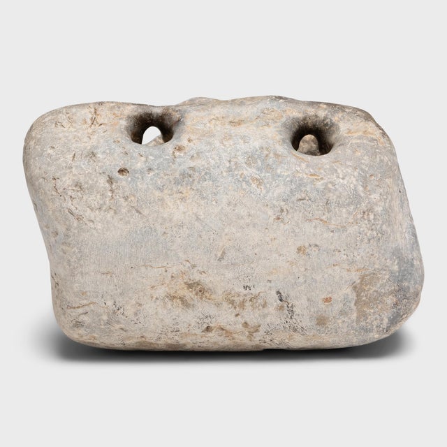Devoid of figurative carvings, this primitive stone weight from the mid-19th century has an organic, abstract beauty. The...