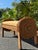 Charming vintage wicker bench featuring a beautifully sculptural silhouette with rounded barrel-style arms and backrests...