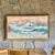 A beautiful watercolor depicting the waves crashing on a low and rustic seaside shore. Serene while capturing the power of...