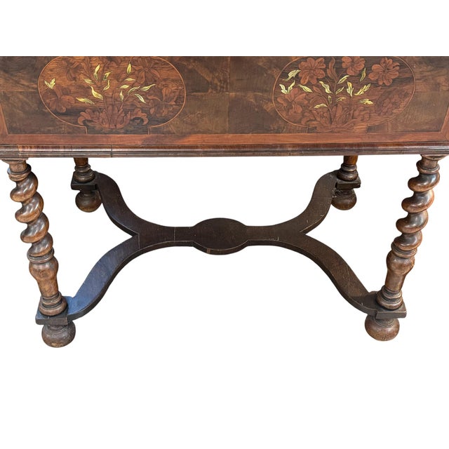 This is an Antique William and Mary style oyster walnut table with intricate marquetry inlay. The table features extensive...