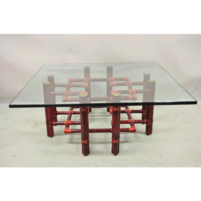 Vintage McGuire Red Rattan Bamboo and Brass Glass Top Square Coffee Table. Item features thick clear glass top, red...