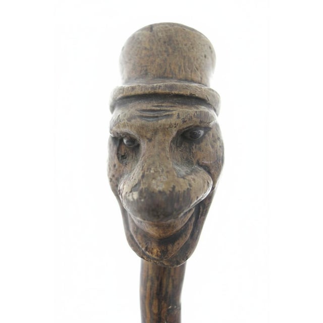 Antique 19th-century monoxyl (single-piece wood) folk art cane, crafted from boxwood showing a carved wood figure with a...