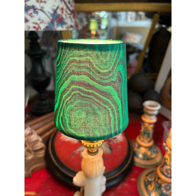 A green malachite print handmade chandelier shade with clip top. Measurements: top 3” bottom 4” side 4”