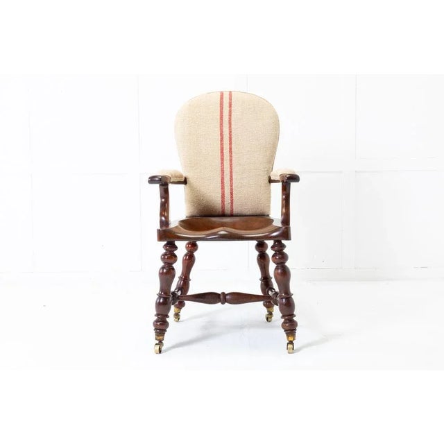 Substantial quality, heavy 19th Century English mahogany armchair with open arms and dished saddle seat. Having nicely...