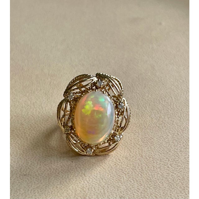 A Huge Cocktail ring Approximately 15 Carat Oval Ethiopian Opal & Emerald Ring 14 Karat Yellow Gold Size 7 This...