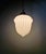 Art Deco pendant light in pressed molded white opaline glass with a copper-plated metal frame, 1920s-30s. The pendant...