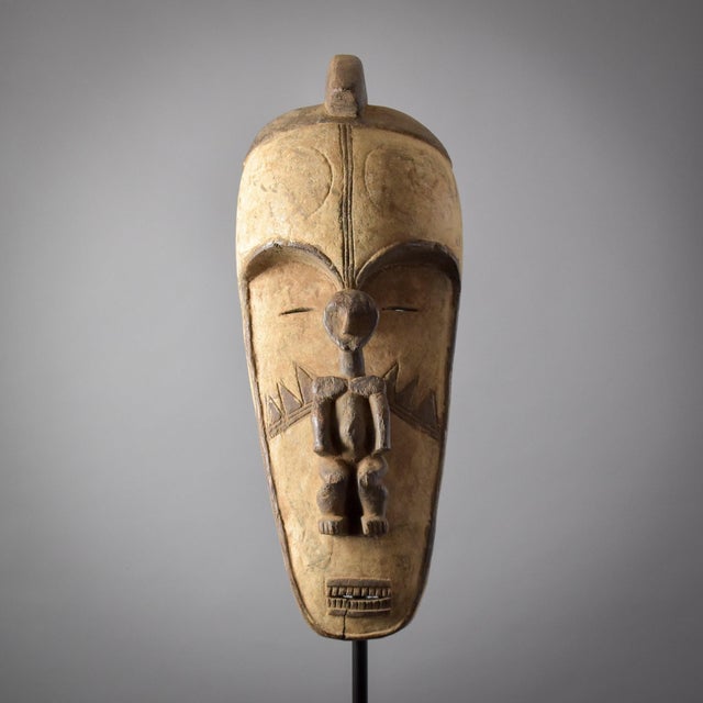 The Fang face mask, displaying wear both on its surface and interior, signifies its age and extensive use.Â It is crafted...
