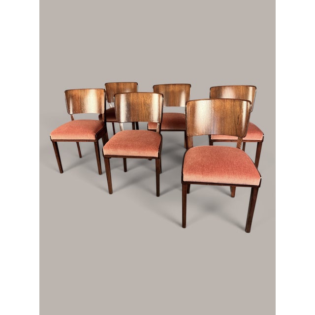 A high-quality set of six German dining chairs from around 1940/50, crafted in walnut or walnut veneer. The chairs are...