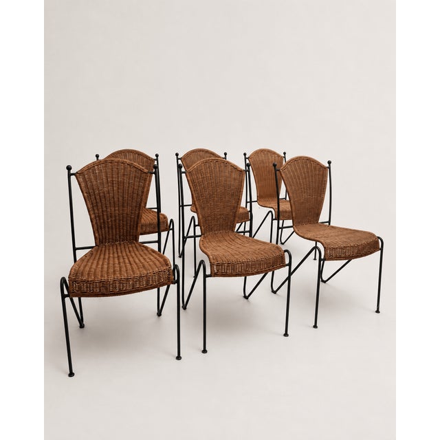A set of six mid-century dining chairs attributed to Frederic Weinberg, combining slender black-lacquered wrought iron...
