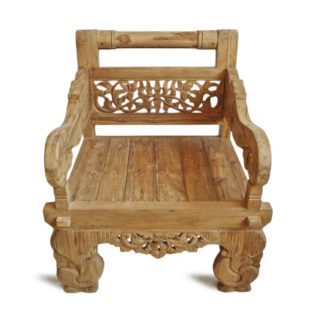 Outdoor teak balinese carved arm chair. Beautiful hand carved back panel and details. Thick and solid scrolling arm rests...