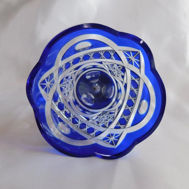 This is a smaller blue cut to clear vase. The entire vase is cut down to the base and the cuts are clean and symmetrical...