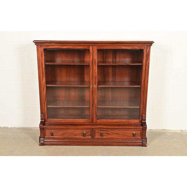 A gorgeous antique Eastlake Victorian bookcase cabinet In the manner of Herter Brothers USA, Circa 1880s Carved mahogany,...