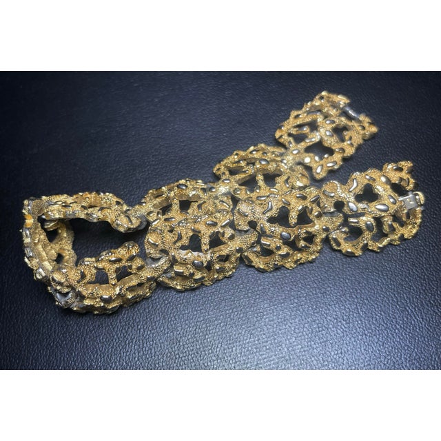 This vintage mid-century modern Trifari bracelet showcases a bold Brutalist design, featuring articulated openwork links...
