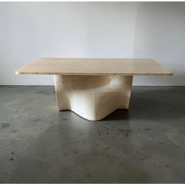 Vintage Italian travertine dining table with an impressive wave-shaped sculptural base. A true centerpiece for any dining...