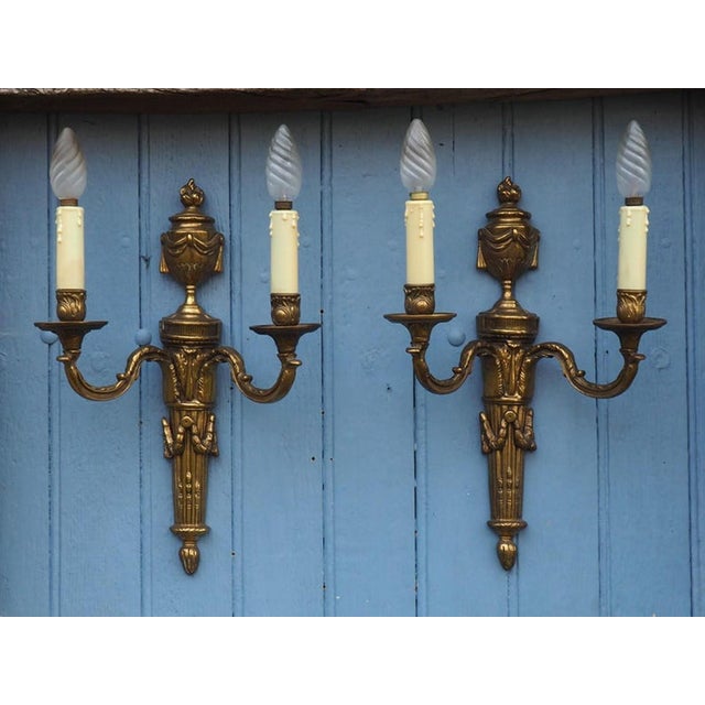 This exquisite antique pair of French twin arm wall lights, crafted from luxurious bronze and brass, brings a touch of...