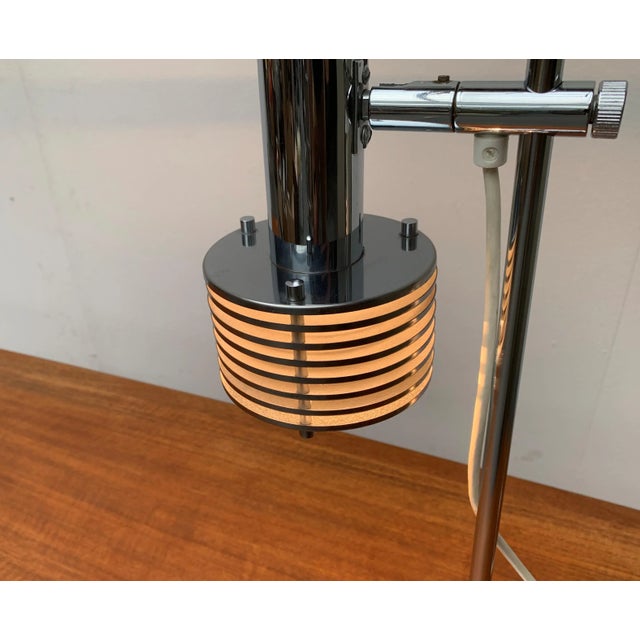 Rare space age table lamp. A distinctive detail of this lamp is the reflector shade, which is dissolved in slats. These...