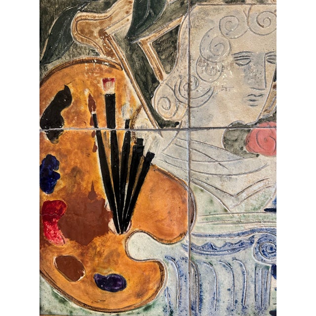 A striking mid-century tile composition featuring an artist’s palette, column, and floral motif in low relief, rendered in...