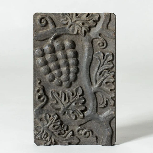 Striking relief by Anna Petrus, made from cast iron. Beautiful motif of grapes on a vine.