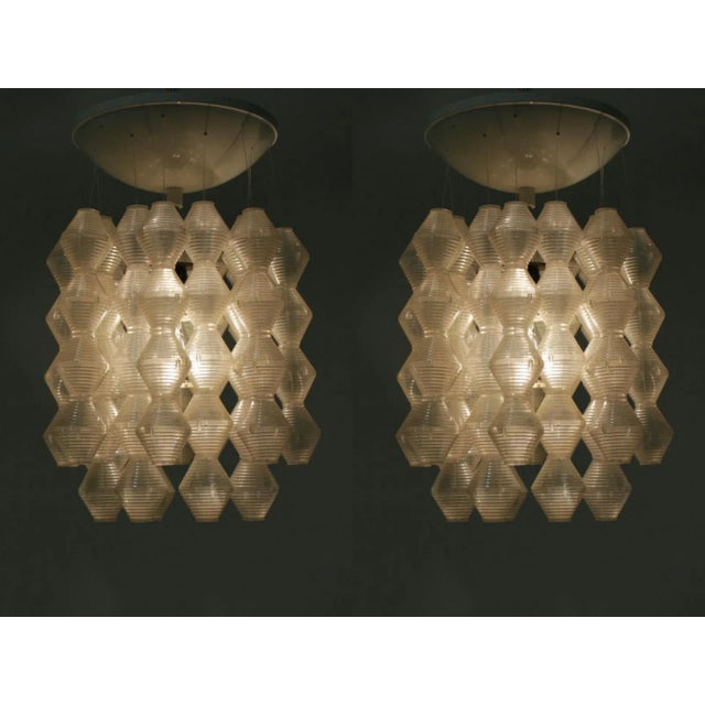This pair of Czechoslovakian pendants in metal and plastic was produced by Napako. Each lamp has one bulb. Labeled by...