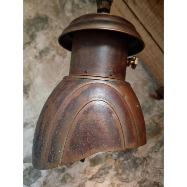 This vintage wall-mounted lamp dates from the 1920s and reflects a combination of Art Deco design and functional...