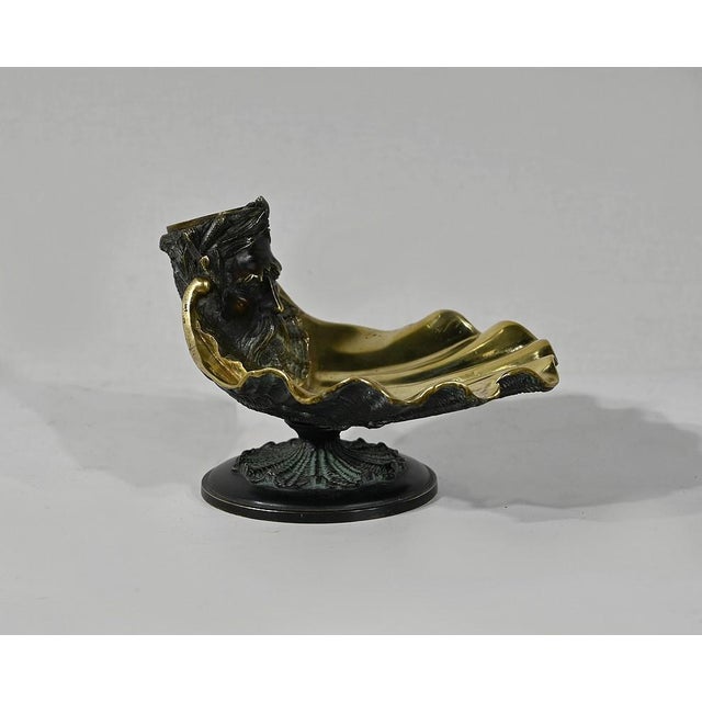 Inkwell bronze shell with golden patina inside and brunette outside. The container represents the face of Neptune, God of...