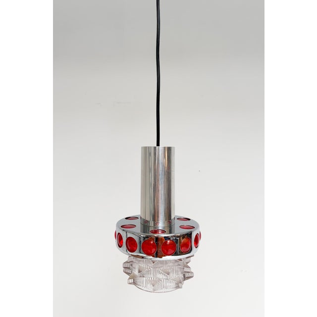 Beautiful vintage Space Age-style pendant lamp by Massive from the 1960s. The lamp is made of chrome-plated metal with red...