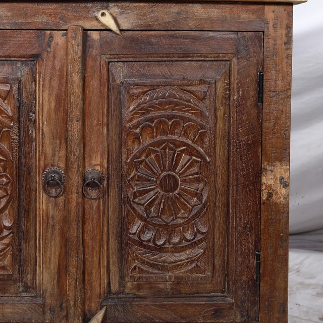 A nightstand crafted from antique Indian carved teakwood elements and reclaimed timber, offering both function and...