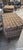 Large woven willow hamper with a hinged lid, metal reinforcement, fastening hardware, and painted ownership lettering....