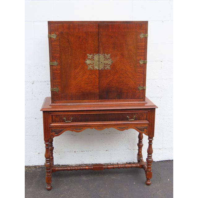 This brilliant China Cabinet is made of wood, rosewood, flame mahogany, veneer, and brass. The Cabinet has Chippendale...