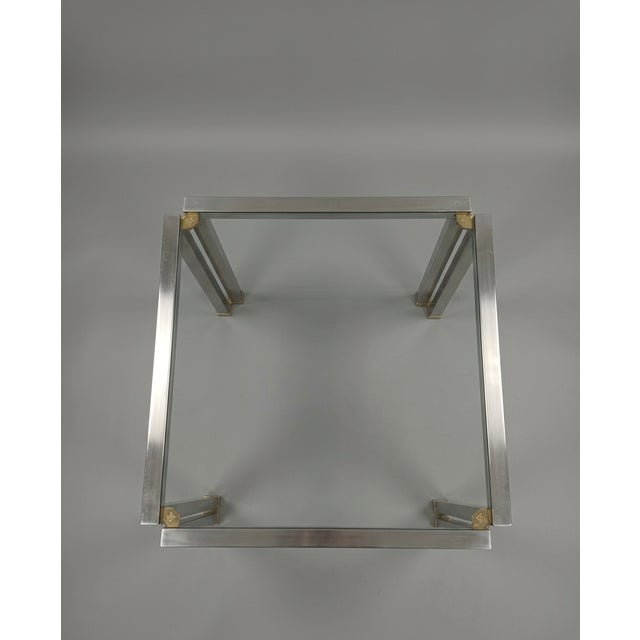 Architectural coffee table by Peter Ghyczy, crafted in brushed aluminium with a clear glass top and refined brass corner...