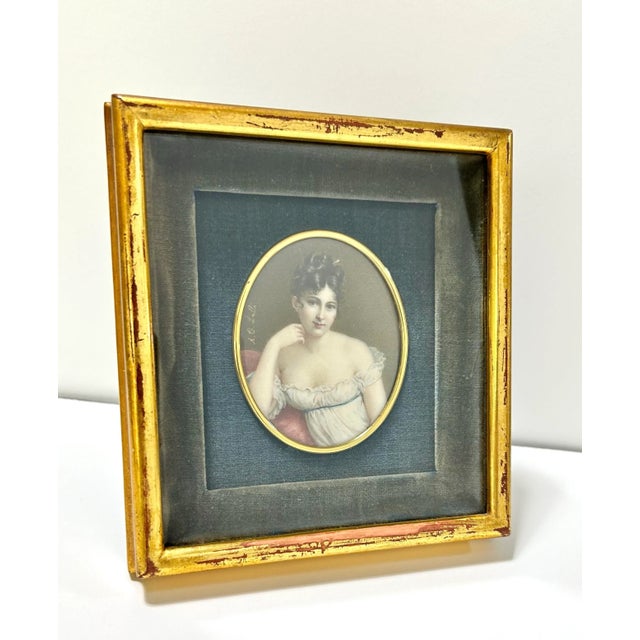 An antique miniature portrait of an elegantly dressed woman, signed “A. Corsi Lalli.” The sitter is depicted in a pale...