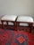 A handsome pair of vintage Ethan Allen stools featuring warm mahogany-toned wood frames, subtly flared legs, and Asian-...