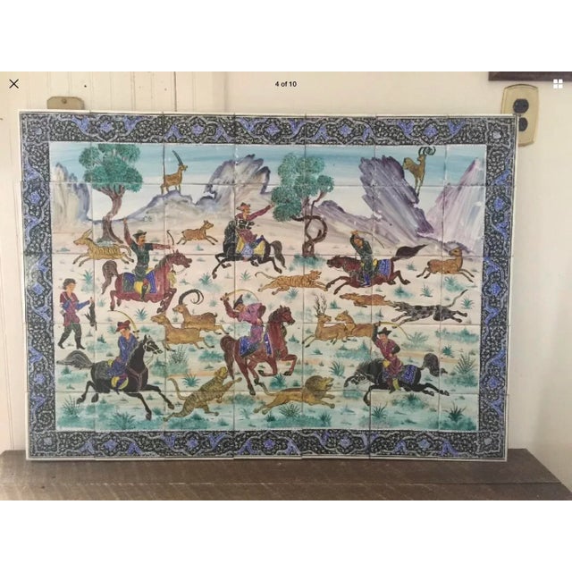 Magnificent hand painted ceramic Persian tiles. 35 individual tiles combined to form a hunting scene and mounted on wood....