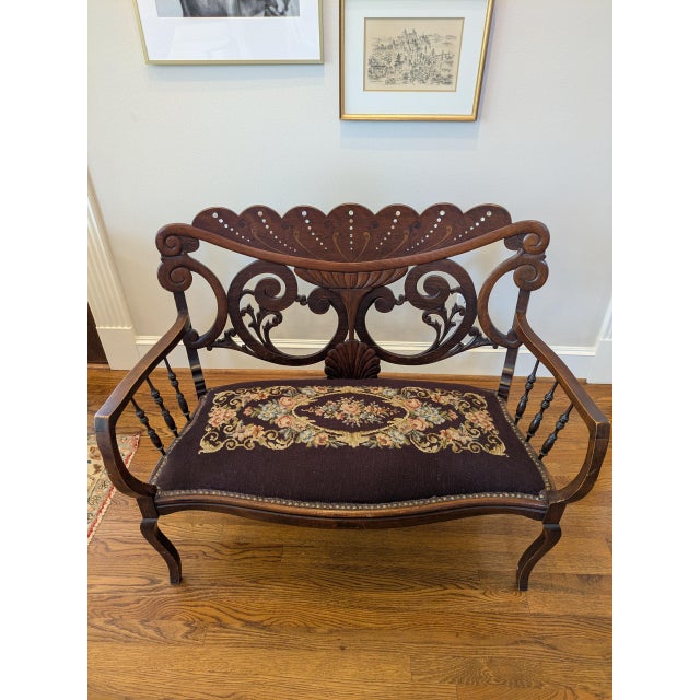 A graceful vintage Edwardian-style settee that brings warmth, elegance, and old-world character to a room. Its beautifully...
