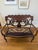 A graceful vintage Edwardian-style settee that brings warmth, elegance, and old-world character to a room. Its beautifully...