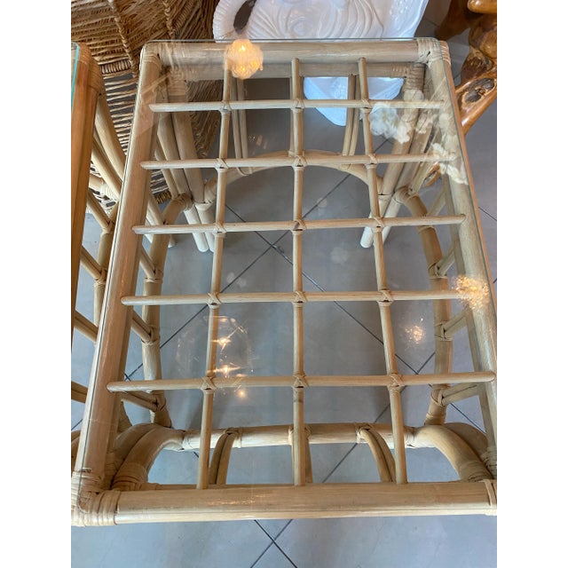 Pair of vintage rattan end side tables with glass top. Natural rattan finish.
