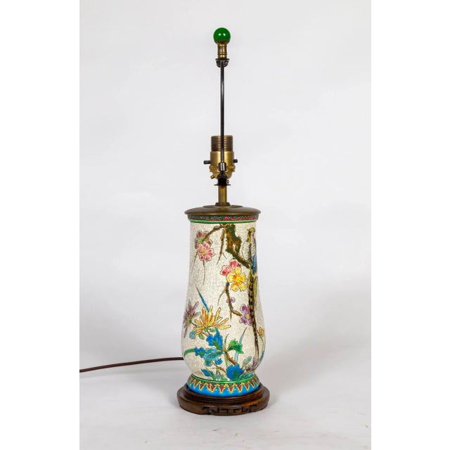 A French Japonisme piece from the early 20th century - this white, crackle glazed ceramic table lamp is intricately hand...
