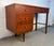 Elegant mid-century modern writing desk featuring a warm walnut wood frame and a durable Formica top. The clean lines and...