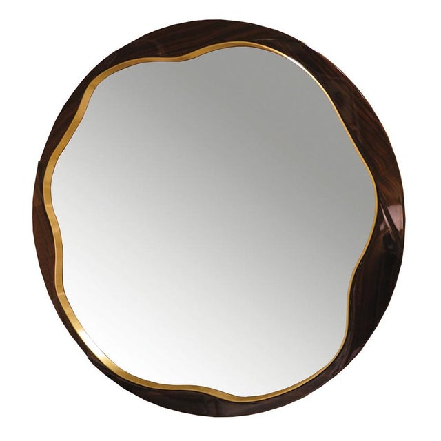 This sleek round mirror features either in Macassar Ebony or lacquered frame. The exterior lines of the frame are a clean...