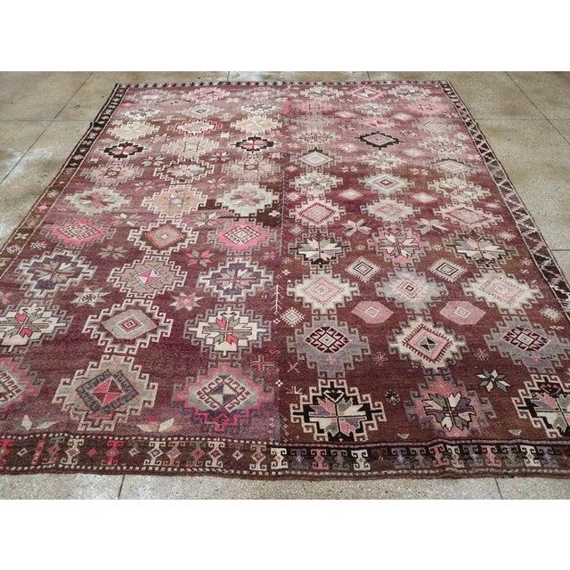 A vintage Turkish Anatolian tribal room size carpet handmade during the mid-20th century. Measures: 10' 11" x 12' 10"