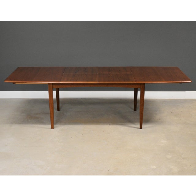A mid century modern teak dining table with two 20.75” butterfly leaves that fully extend the table to 109.5” wide. Made...