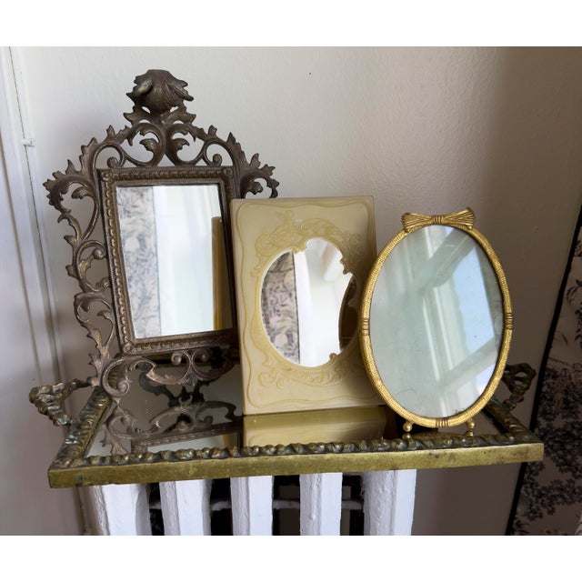 Vintage tabletop vanity easel mirror featuring Rococo Revival styling with ornate molded relief decoration. The frame is...