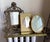 Vintage tabletop vanity easel mirror featuring Rococo Revival styling with ornate molded relief decoration. The frame is...