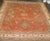 A large late 19th Century Antique Oushak rug featuring a large scale all over design floating on a pumpkin orange field...