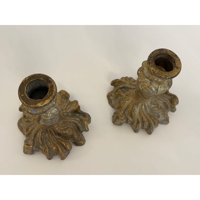 Ornate, rustic brass candle stick holders created to hold standard tapered candles. They feature inticate stylized floral...