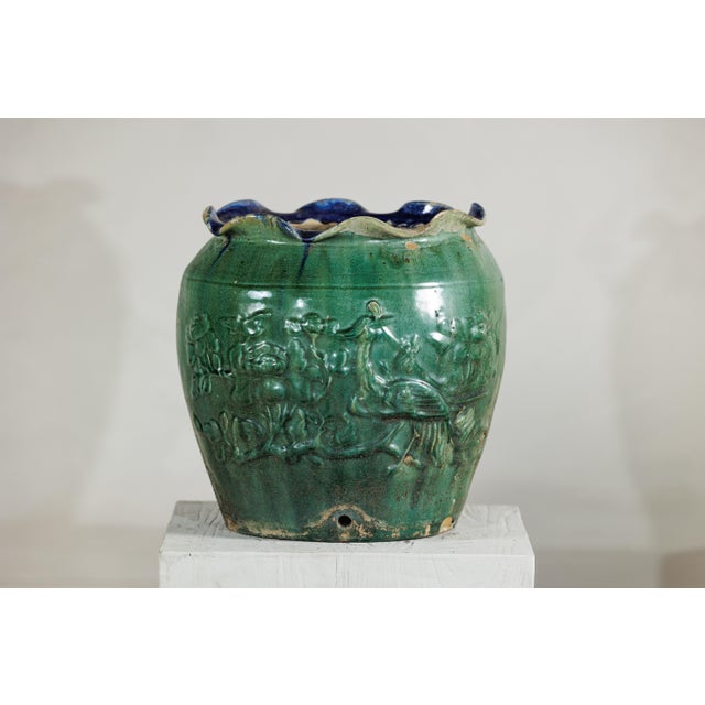 An antique Vietnamese Annamese planter, distinguished by its vivid green glaze and sculptural surface detail. The vessel’s...