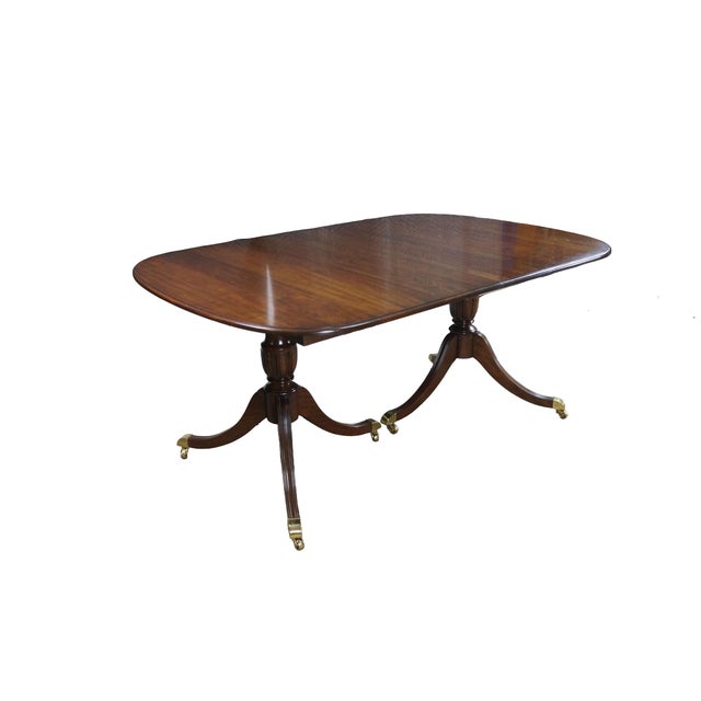 Vintage Harden Furniture solid cherry extendable dining table, circa late 20th Century. A beautiful blend of traditional...